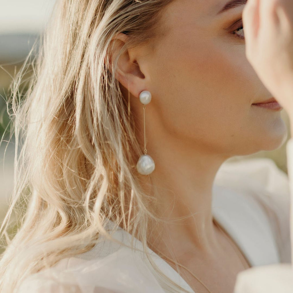 Pearl stud drop earrings, secured on fine chain