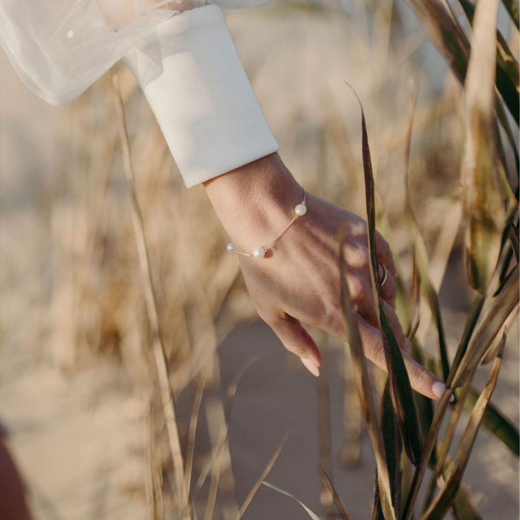 a fine pearl bracelet with 5 pearls evenly spaced with chain in between